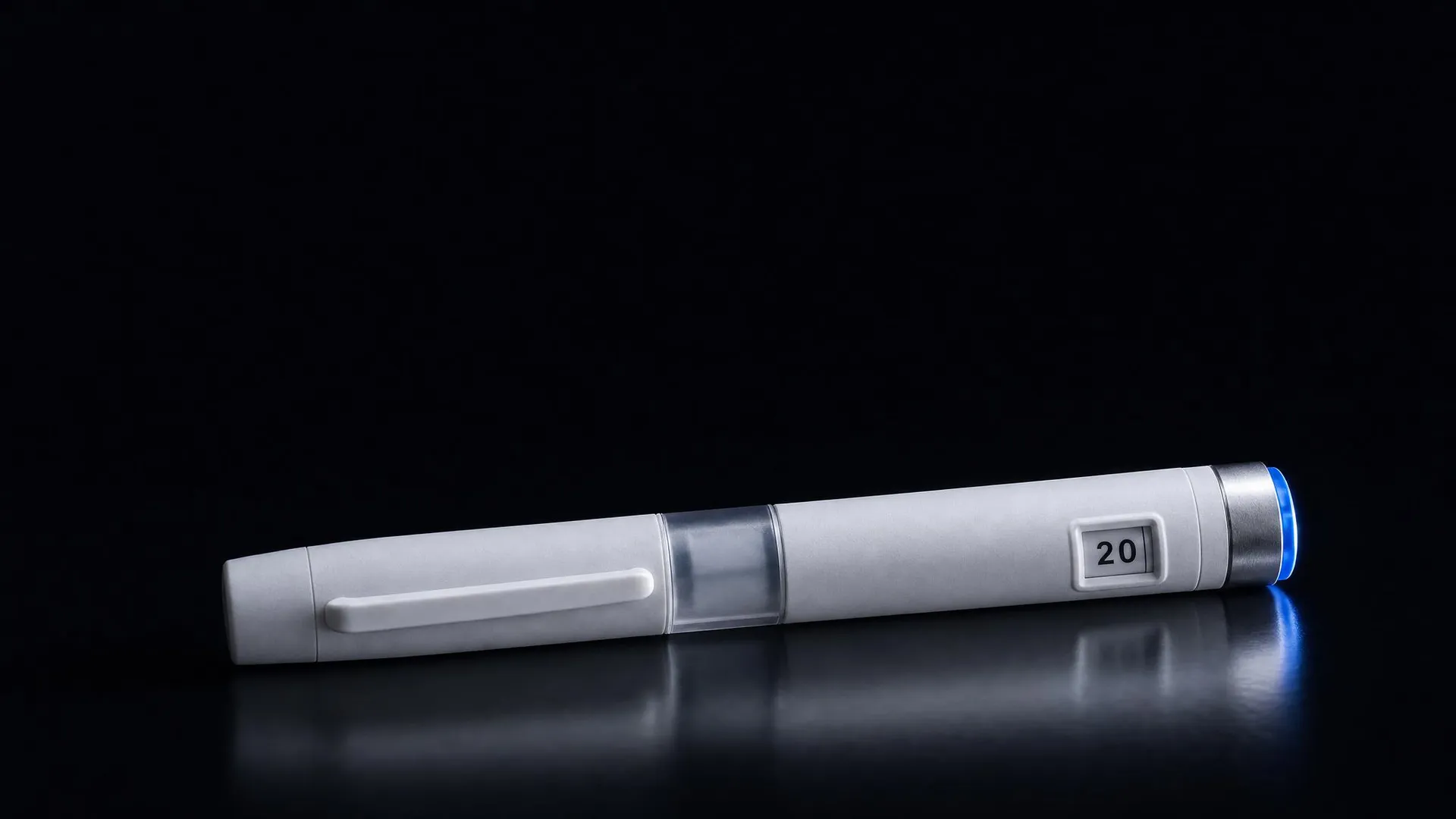 The Pep Pen lit on a dark surface, the steel dose dial and blue indicator ring catching the light
